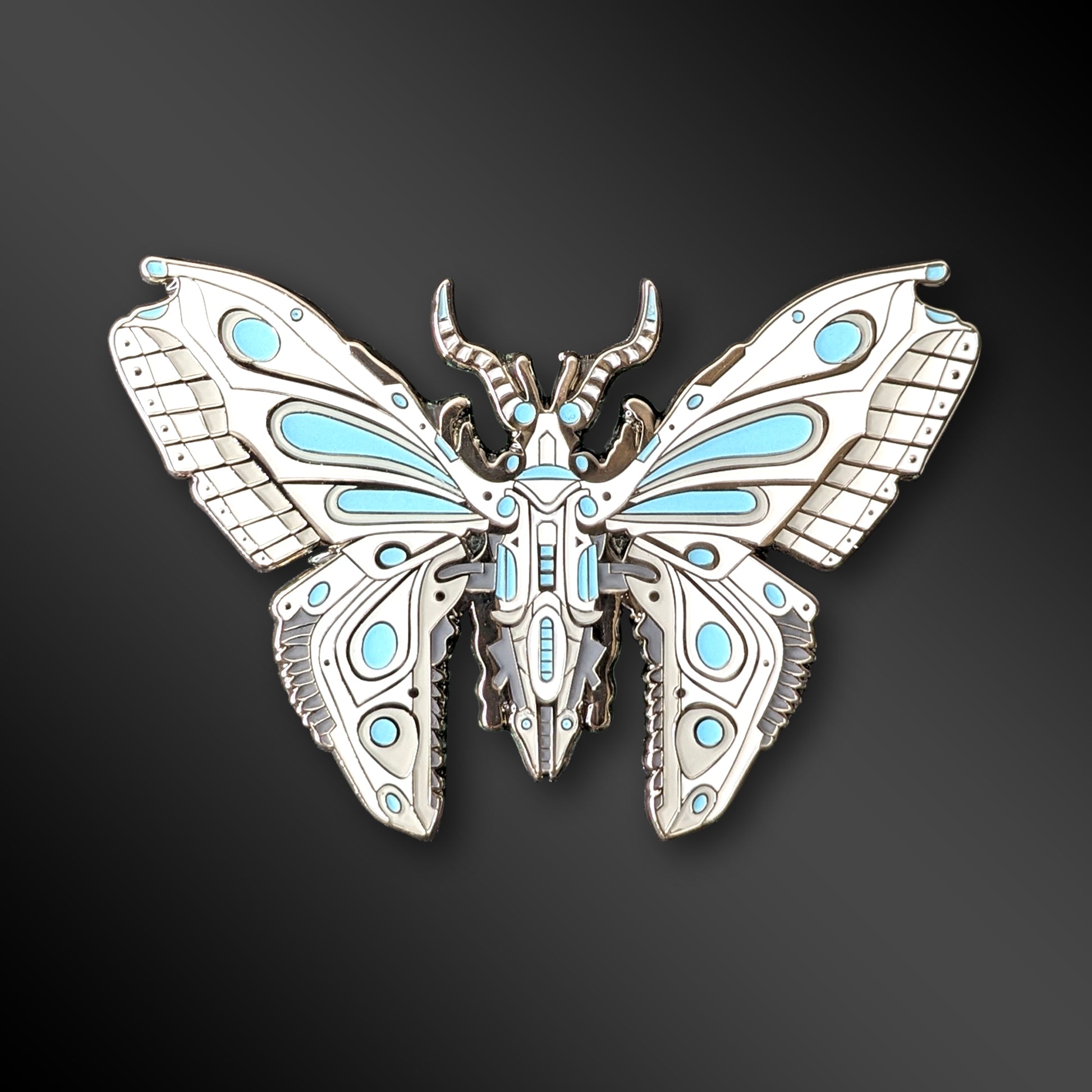 Blue Robot Butterfly enamel pin with mechanical wings and glow-in-the-dark details